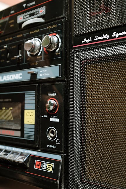 Vintage boombox showcasing classic design with close-up on controls and speaker.