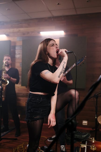 Energetic female singer leads an indie band rehearsal with passion and intensity.